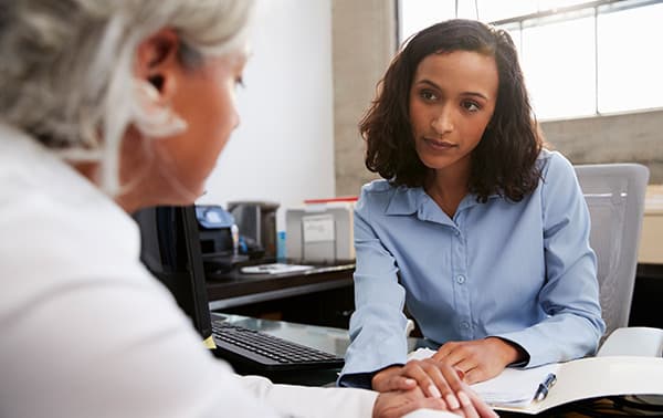 Advisor consoling a patient